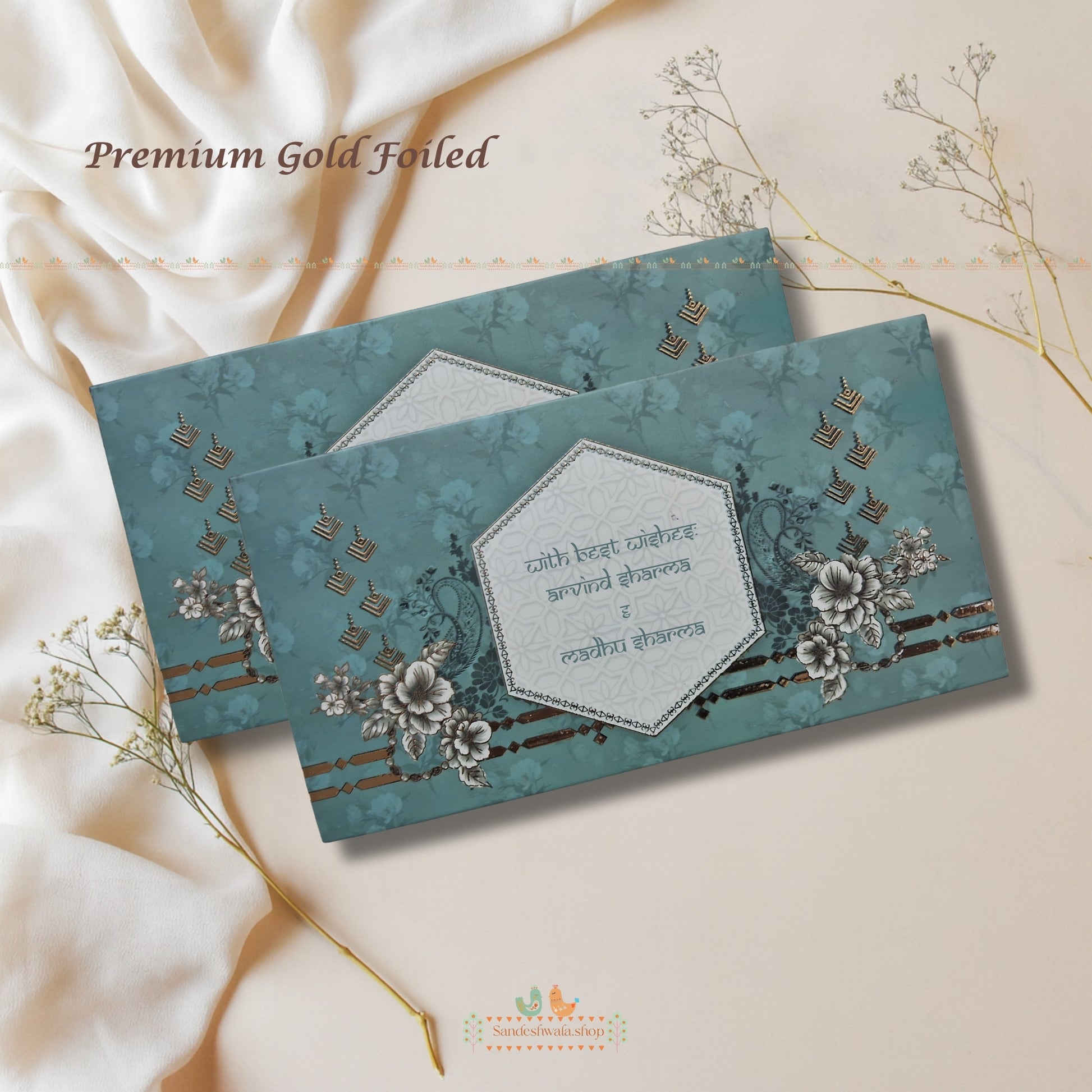 Decorative envelopes with floral patterns and gold text on a soft beige background