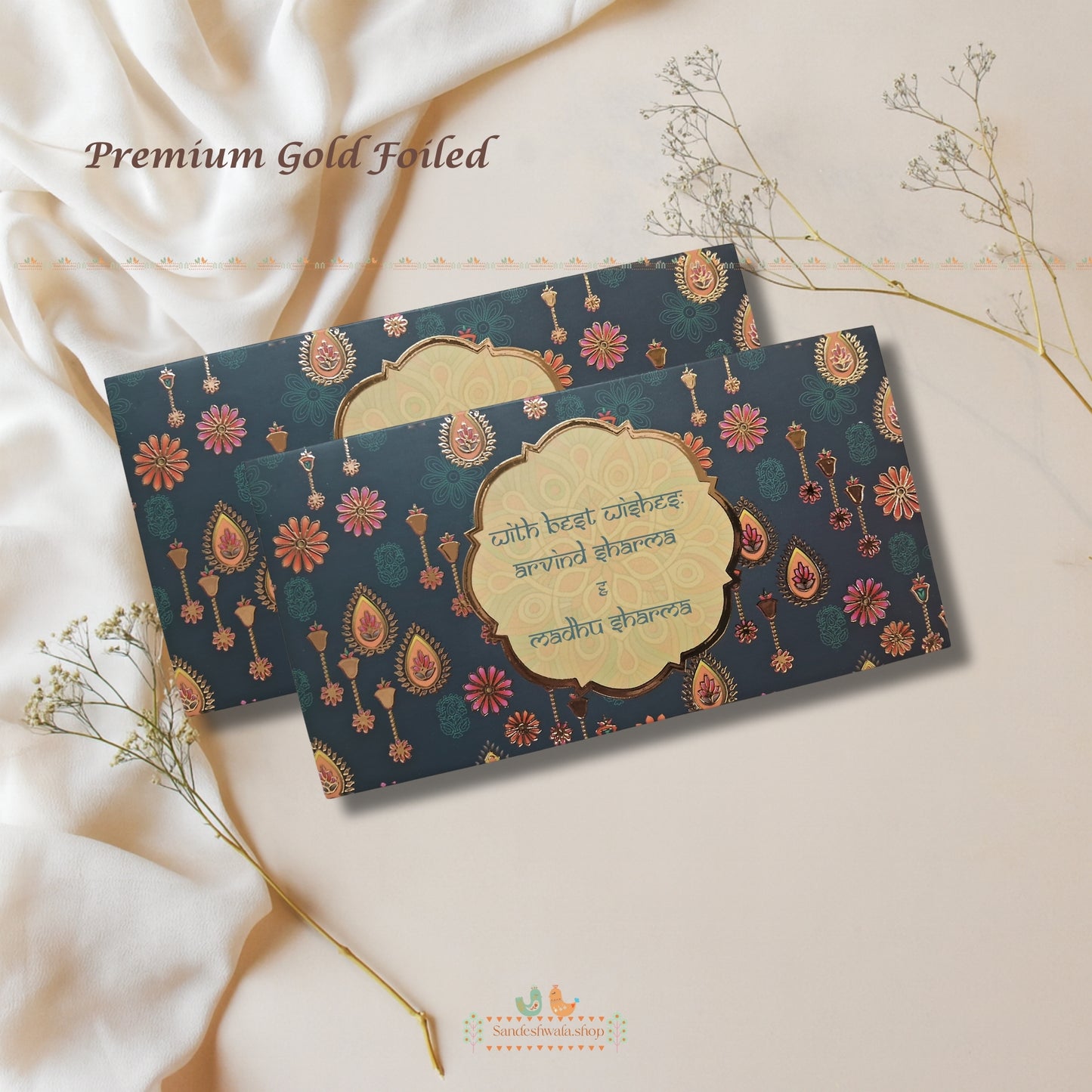 Two premium gold-foiled cards with decorative patterns on a soft beige background.