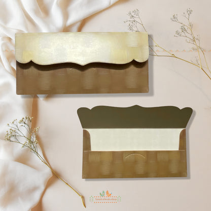 Two gold envelopes with white interior on a soft beige background